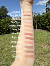 Lipstick swatches on a person's arm with outdoor background