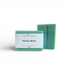 Two green bars of soap with a label on a white background